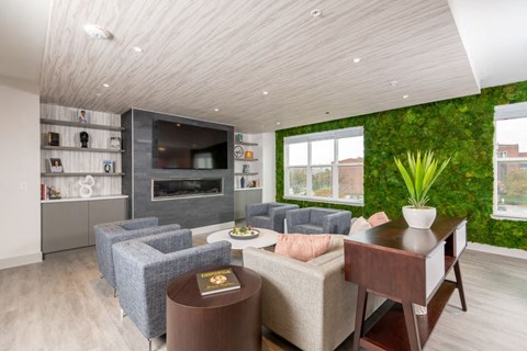 a living room with a green wall and a couch and a table